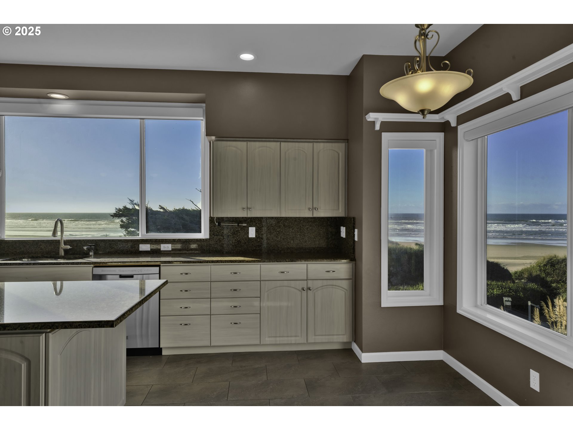 88765 Shoreline Loop Florence, OR 97439 - Photo 18 of 48 a kitchen with stainless steel appliances granite countertop a stove a sink and a microwave