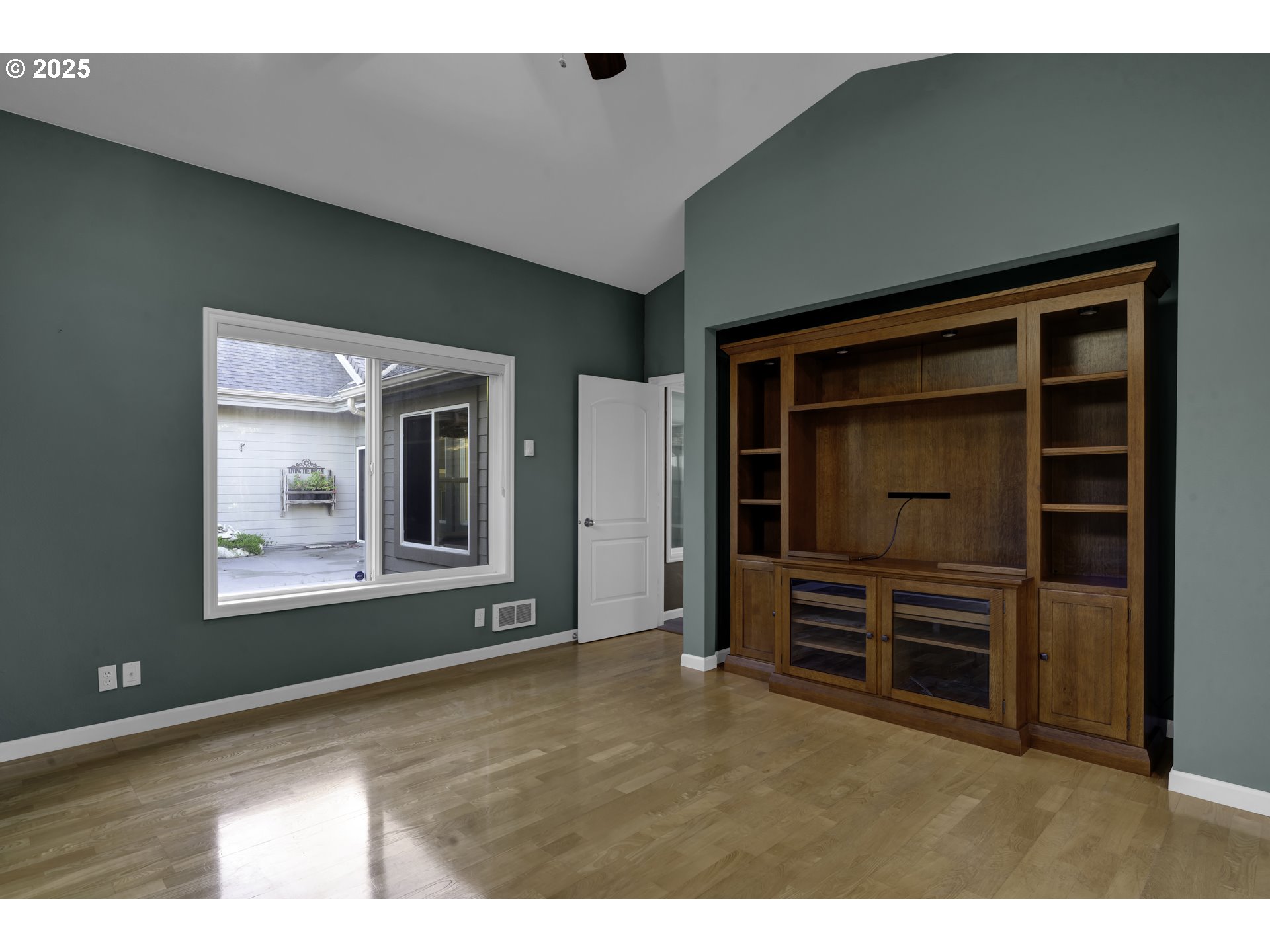 88765 Shoreline Loop Florence, OR 97439 - Photo 26 of 48 a view of an empty room with cabinet and a flat screen tv
