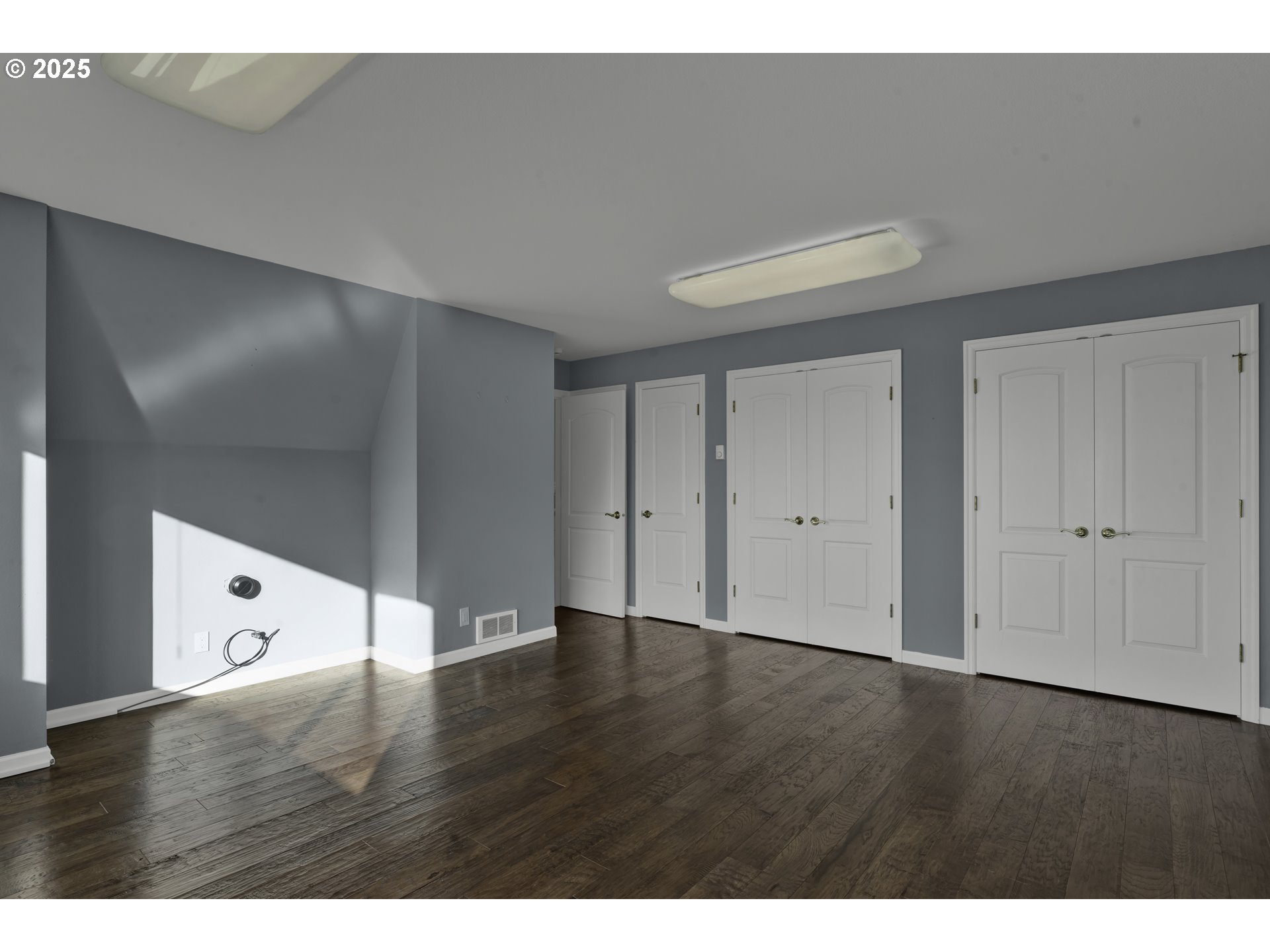 88765 Shoreline Loop Florence, OR 97439 - Photo 32 of 48 a view of an empty room with wooden floor