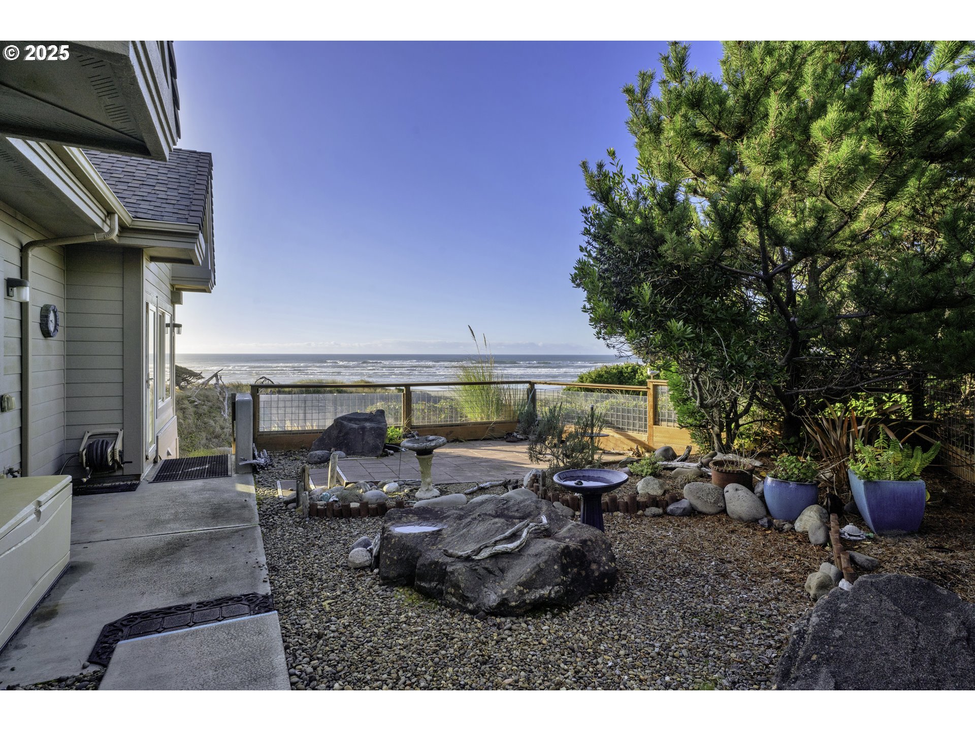 88765 Shoreline Loop Florence, OR 97439 - Photo 40 of 48 a view of a patio with table and chairs under an umbrella