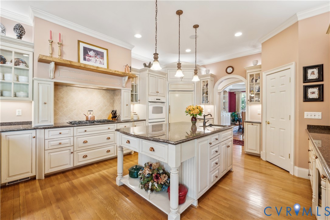 13901 Dunkeld Terrace Midlothian, VA 23113 - Photo 12 of 44 a large white kitchen with lots of counter space and wooden floor