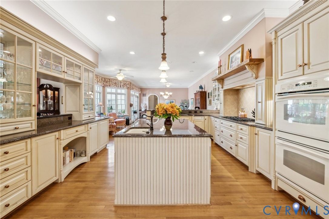 13901 Dunkeld Terrace Midlothian, VA 23113 - Photo 14 of 44 a large white kitchen with lots of counter space wooden floor and appliances