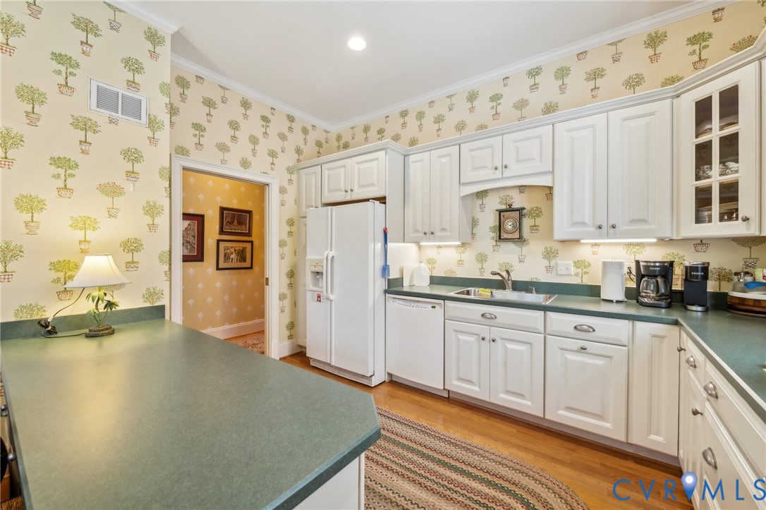 13901 Dunkeld Terrace Midlothian, VA 23113 - Photo 27 of 44 a kitchen with granite countertop white cabinets a refrigerator and a sink