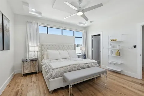 a bedroom with furniture and flat screen tv
