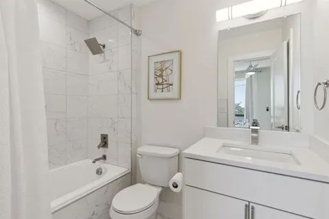 a view of a balcony with two chairs and a table