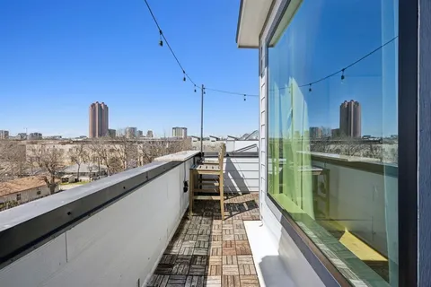 a view of a balcony with an outdoor seating