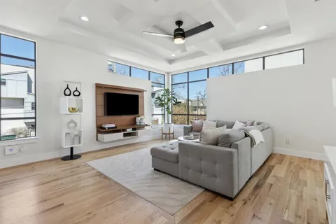 a view of a kitchen with wooden floor and a sink