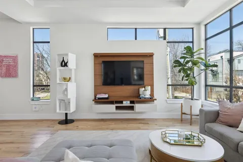 a kitchen with kitchen island a sink stainless steel appliances and wooden floor