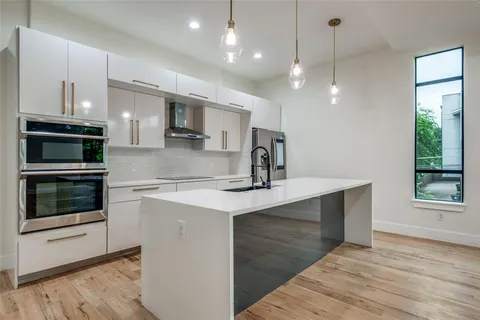 a kitchen with stainless steel appliances a sink and a stove