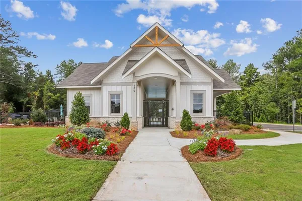 a front view of a house with fountain and garden