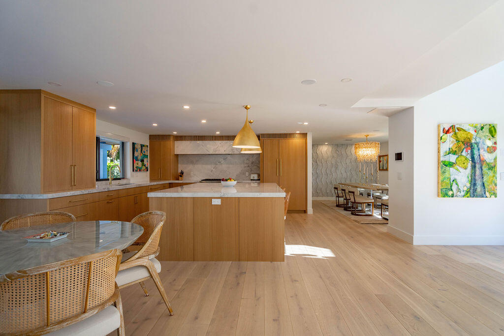 3001 Northeast 52nd Street Lighthouse Point, FL 33064 - Photo 13 of 61 a kitchen with a table and chairs