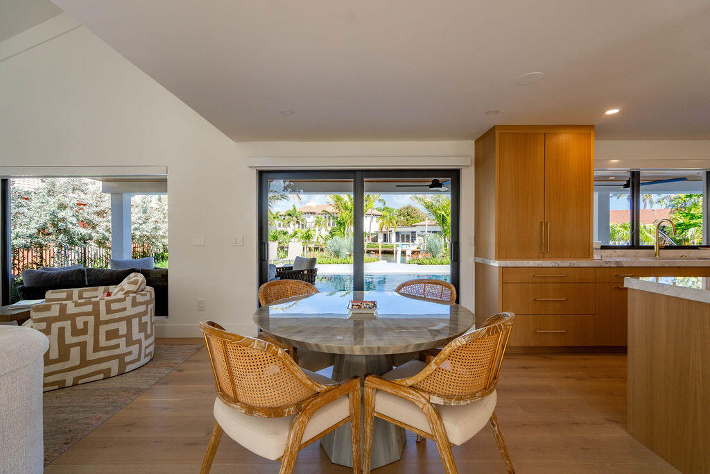 3001 Northeast 52nd Street Lighthouse Point, FL 33064 - Photo 16 of 61 a dining room with furniture and a floor to ceiling window