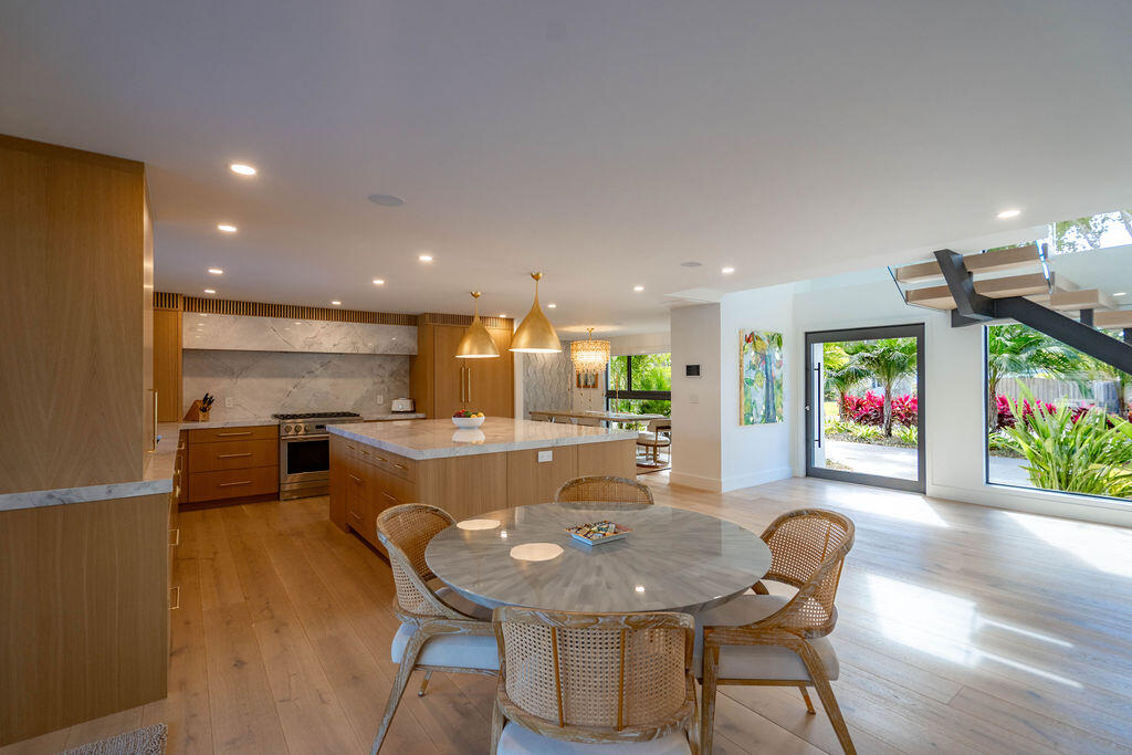 3001 Northeast 52nd Street Lighthouse Point, FL 33064 - Photo 18 of 61 a dining room with furniture a floor to ceiling window and wooden floor