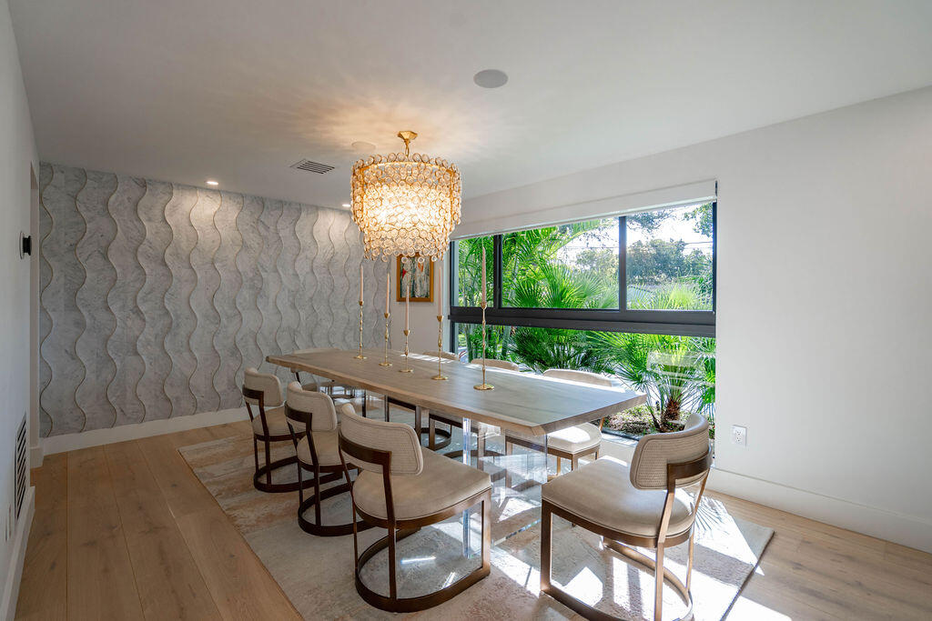 3001 Northeast 52nd Street Lighthouse Point, FL 33064 - Photo 19 of 61 a view of a dining room with furniture wooden floor and chandelier