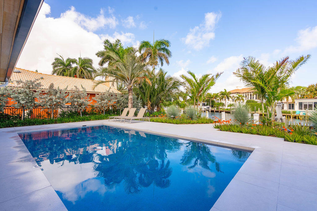 3001 Northeast 52nd Street Lighthouse Point, FL 33064 - Photo 50 of 61 a view of a swimming pool with a yard