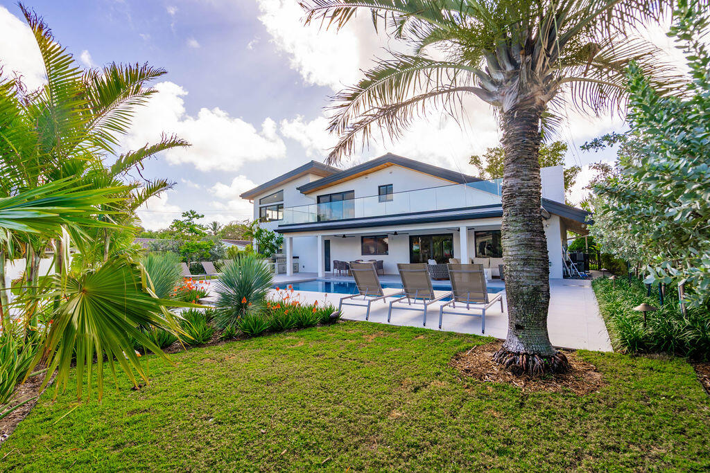 3001 Northeast 52nd Street Lighthouse Point, FL 33064 - Photo 58 of 61 a front view of a house with garden and sitting area