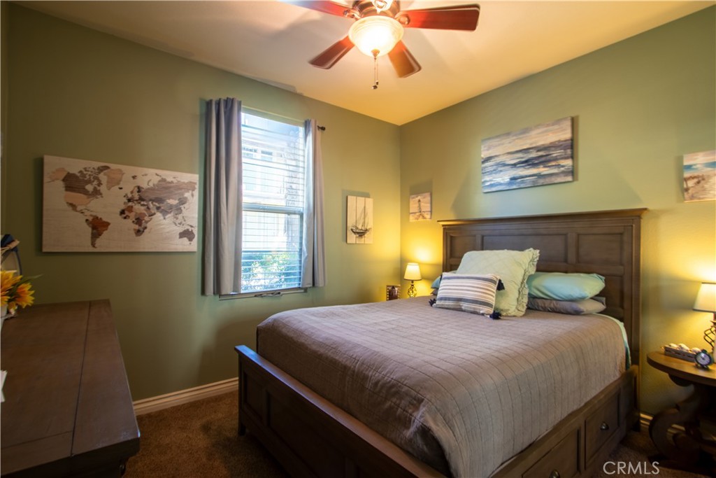 8090 Cornwall Court, Unit 38 Rancho Cucamonga, CA 91739 - Photo 11 of 47 a bedroom with a bed and a chandelier