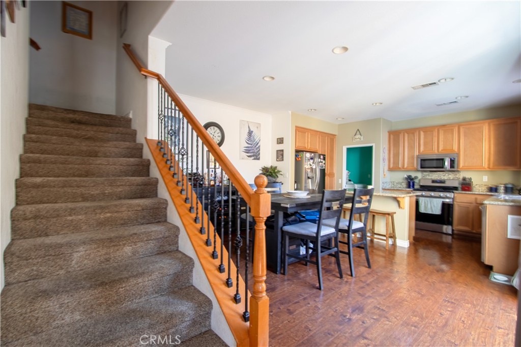 8090 Cornwall Court, Unit 38 Rancho Cucamonga, CA 91739 - Photo 13 of 47 a dining room with furniture entryway and kitchen view