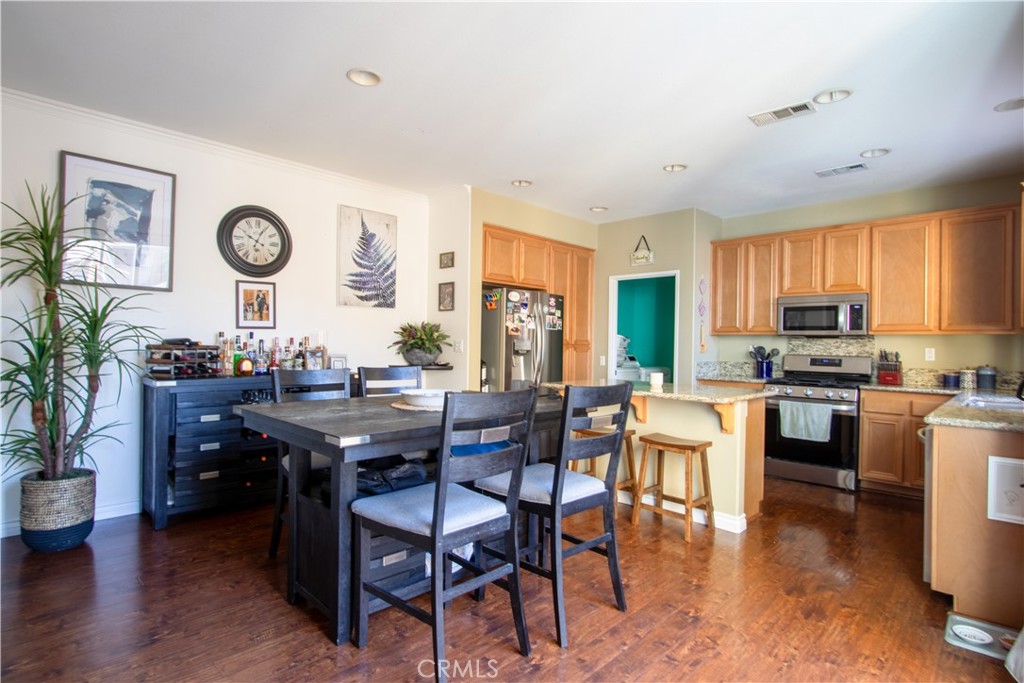 8090 Cornwall Court, Unit 38 Rancho Cucamonga, CA 91739 - Photo 14 of 47 a view of a dining room with furniture window and wooden floor