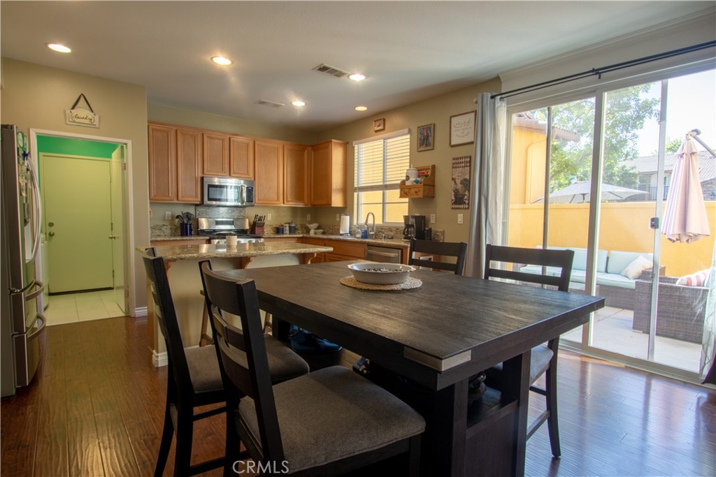 8090 Cornwall Court, Unit 38 Rancho Cucamonga, CA 91739 - Photo 19 of 47 a view of a dining room with furniture window and outside view