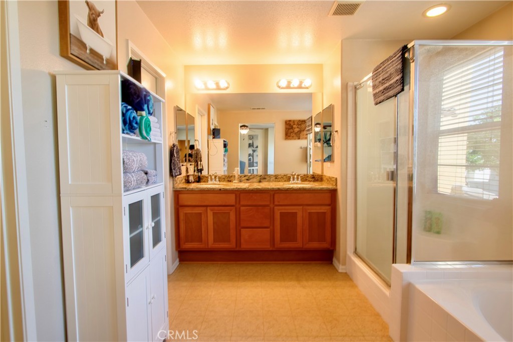8090 Cornwall Court, Unit 38 Rancho Cucamonga, CA 91739 - Photo 22 of 47 a bathroom with a double vanity sink and mirror