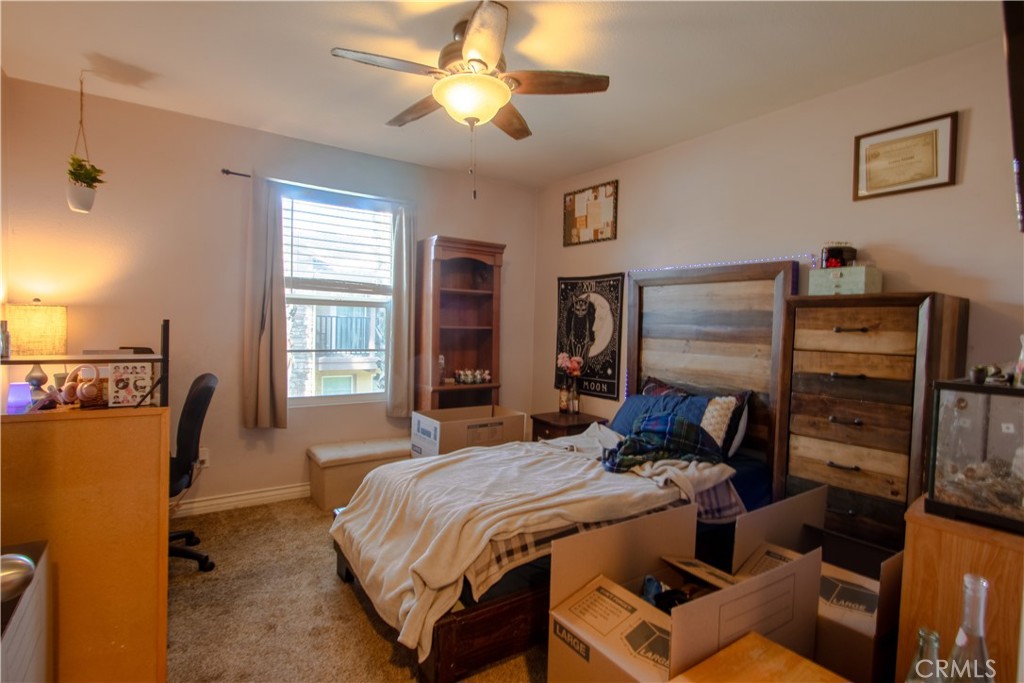 8090 Cornwall Court, Unit 38 Rancho Cucamonga, CA 91739 - Photo 24 of 47 a bedroom with a bed and wooden floor