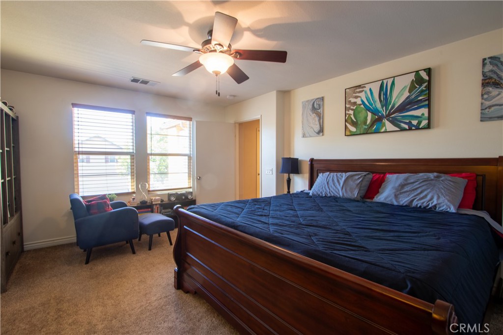 8090 Cornwall Court, Unit 38 Rancho Cucamonga, CA 91739 - Photo 30 of 47 a bed room with a bed and a chandelier