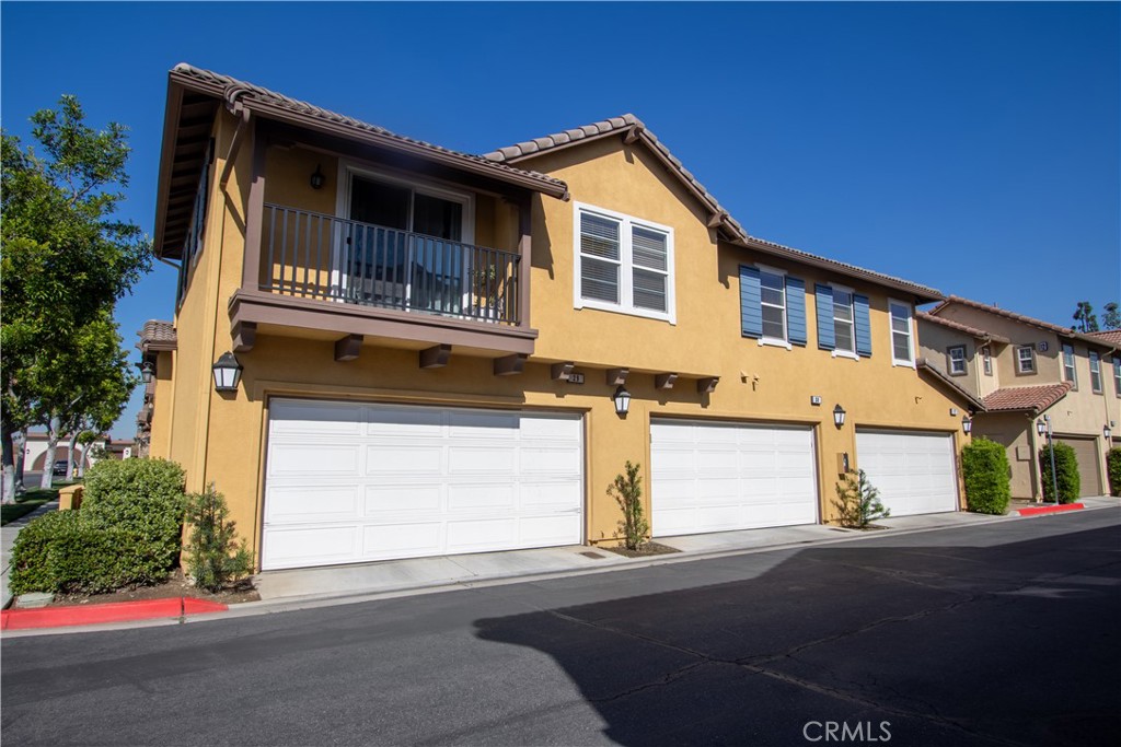 8090 Cornwall Court, Unit 38 Rancho Cucamonga, CA 91739 - Photo 3 of 47 a front view of a house with a garage