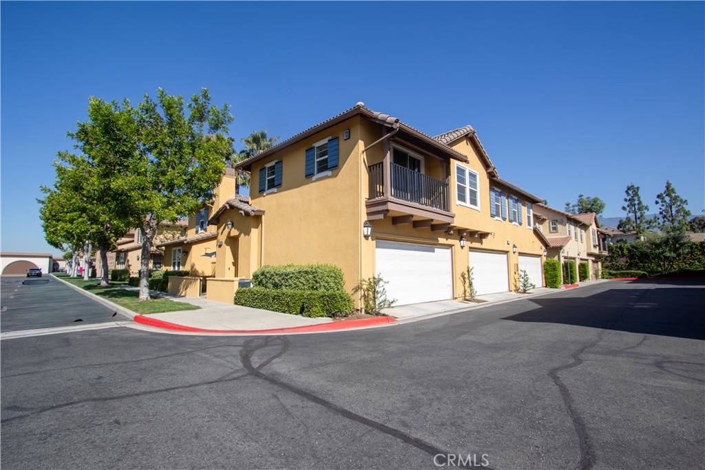 8090 Cornwall Court, Unit 38 Rancho Cucamonga, CA 91739 - Photo 36 of 47 a front view of a house with a yard and garage