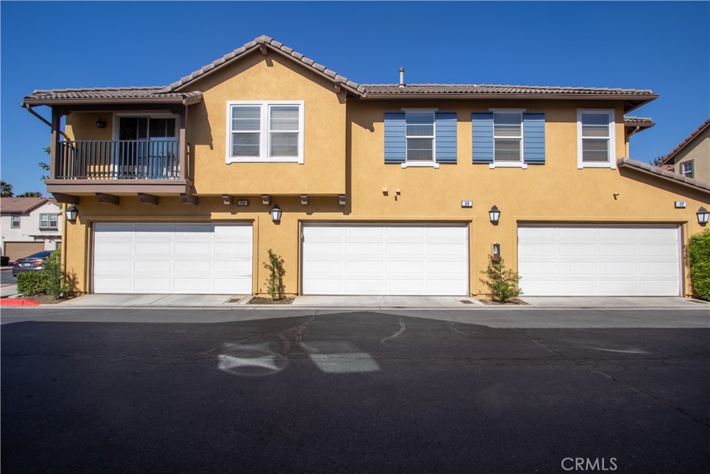 8090 Cornwall Court, Unit 38 Rancho Cucamonga, CA 91739 - Photo 37 of 47 a front view of a house with a yard and garage