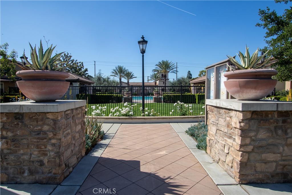 8090 Cornwall Court, Unit 38 Rancho Cucamonga, CA 91739 - Photo 39 of 47 a view of a backyard with potted plants