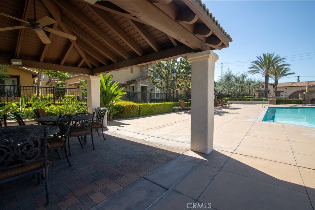 8090 Cornwall Court, Unit 38 Rancho Cucamonga, CA 91739 - Photo 40 of 47 a view of a porch with chairs and a yard