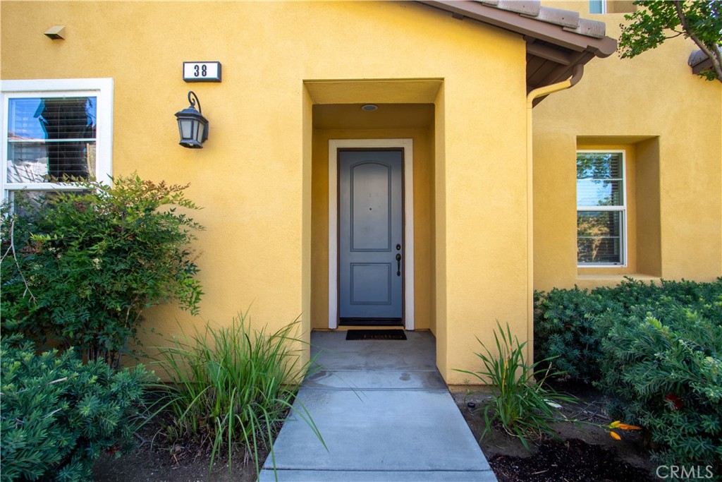 8090 Cornwall Court, Unit 38 Rancho Cucamonga, CA 91739 - Photo 4 of 47 a front view of a house with a yard