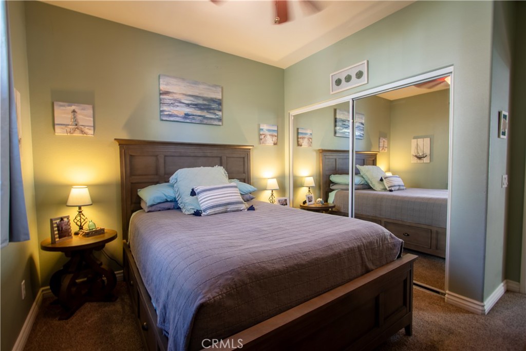 8090 Cornwall Court, Unit 38 Rancho Cucamonga, CA 91739 - Photo 10 of 47 a bedroom with a bed and wooden floor