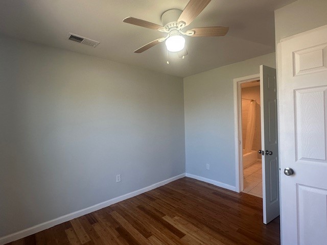 737 Webb Street Corpus Christi, TX 78418 - Photo 6 of 8 an empty room with wooden floor and a ceiling fan