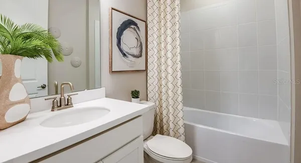 a bathroom with a sink toilet a mirror and shower