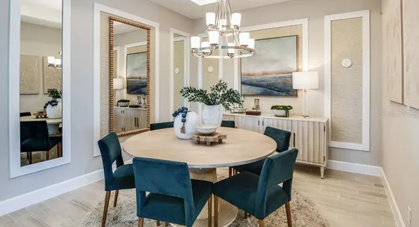 a view of a dining room with furniture and wooden floor