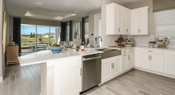 a kitchen with a sink cabinets and wooden floor