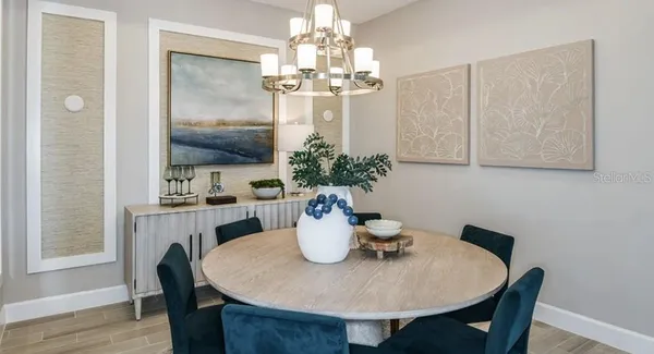 a view of a dining room with furniture and chandelier