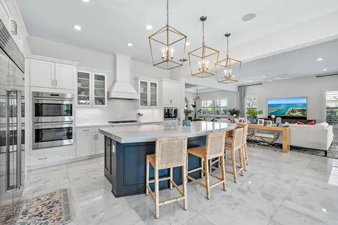 a bathroom with a tub a double vanity sink a large mirror and a shower