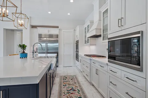 a dining room with furniture a chandelier and wooden floor