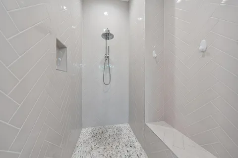 a bathroom with a granite countertop shower sink vanity mirror and toilet