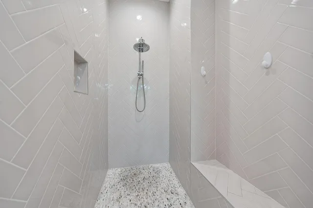 a bathroom with a granite countertop shower sink vanity mirror and toilet
