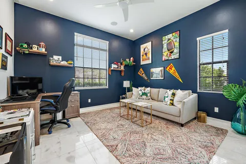 a spacious bedroom with a bed and wooden floor