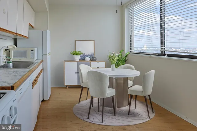 a dining room with furniture and window
