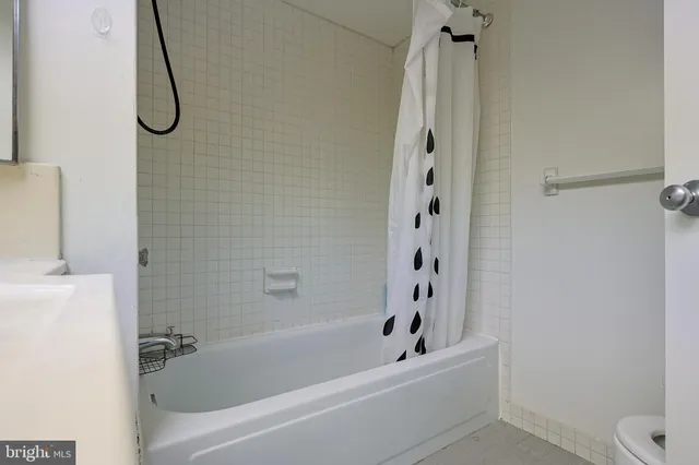 a bathroom with a bath tub with a shower