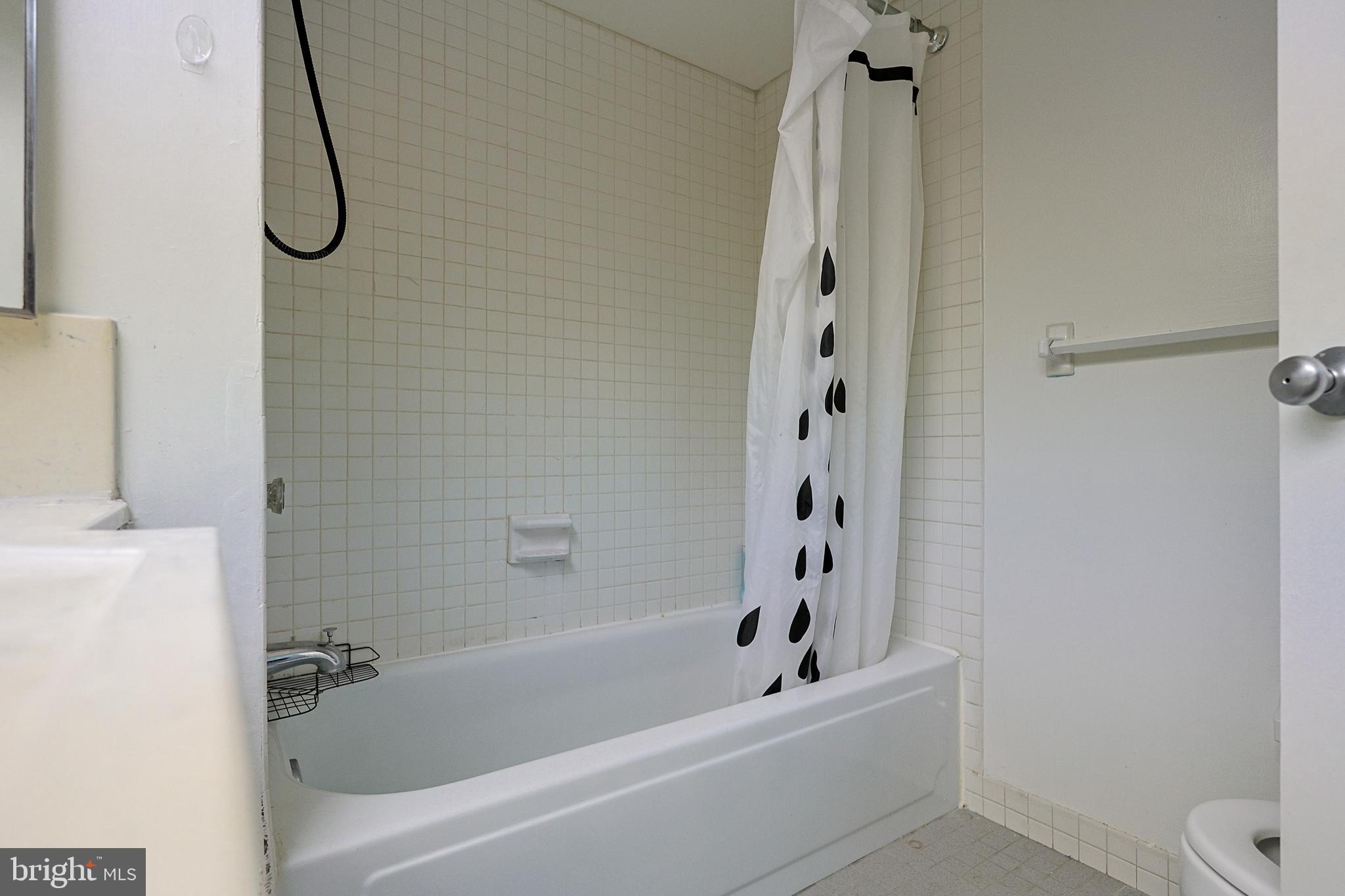 1326 Spruce Street, Unit 1602 Philadelphia, PA 19107 - Photo 6 of 11 a bathroom with a bath tub with a shower