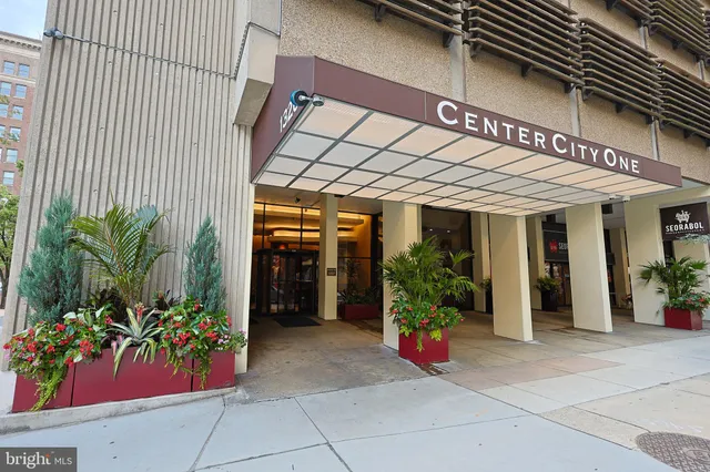 a view of a house with potted plants