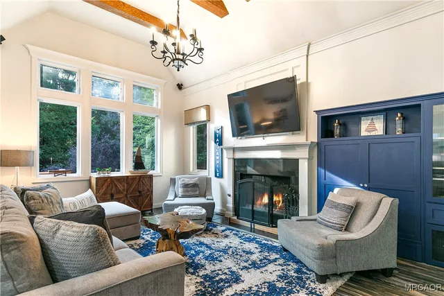 a living room with furniture a fireplace and a flat screen tv