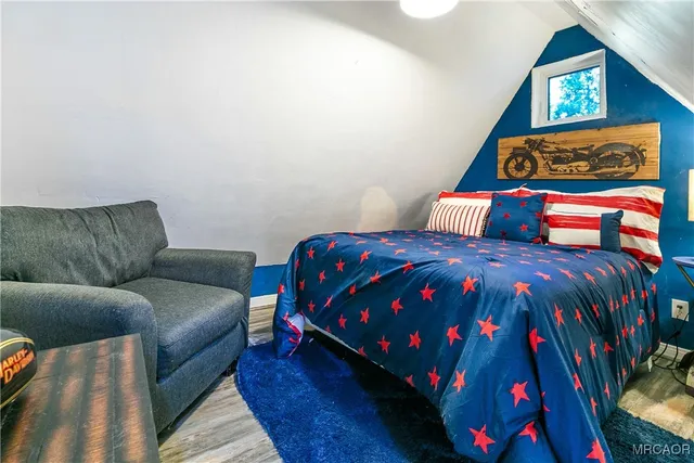 a bedroom with a bed and a couch